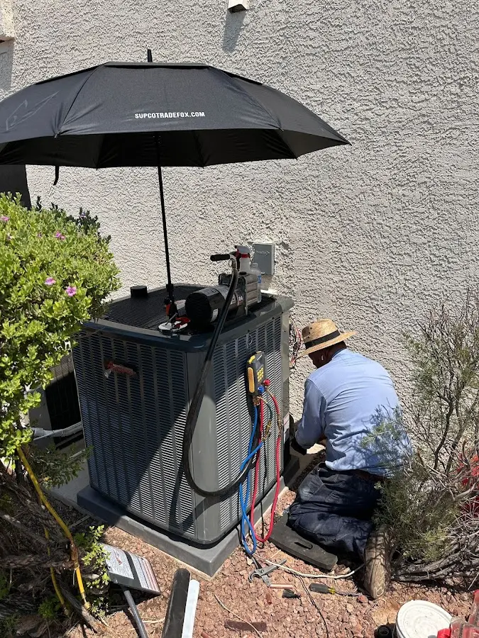 HVAC technician performing outdoor AC maintenance in Townsend